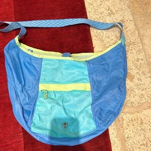 IVIVA hobo style bag. Nylon snap closure.